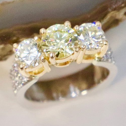 Three large stone diamond ring set in pave band